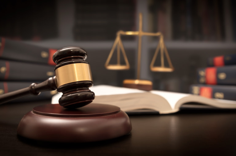 A gavel and scales of justice in a lawyers office