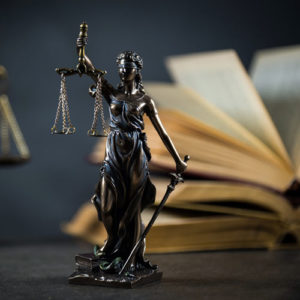 A statue of Lady Justice on a desk