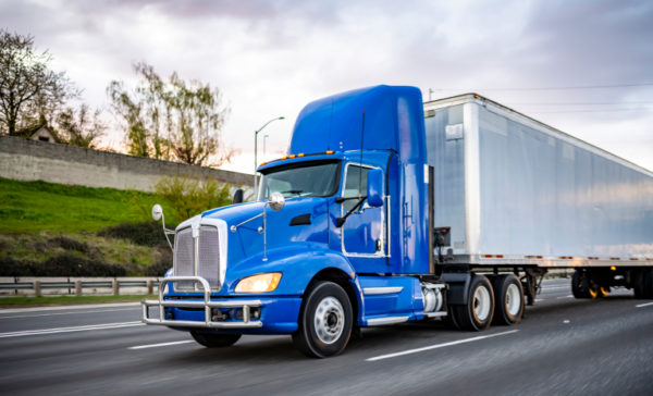 semi truck driving down a highway