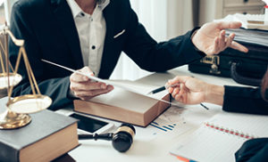 A medical device recall attorney goes over paperwork with a client