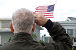 Elderly man salutes the flag