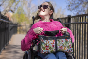 A child uses a wheelchair to get around outside