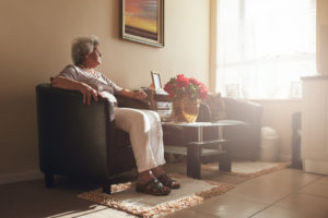 older woman sitting in a chair alone