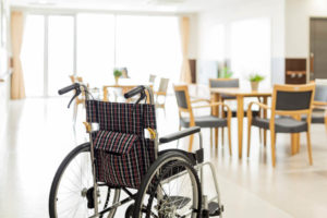 An empty wheelchair in a nursing home