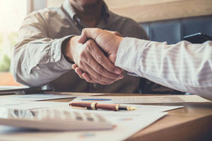 A man shakes hands with a lawyer