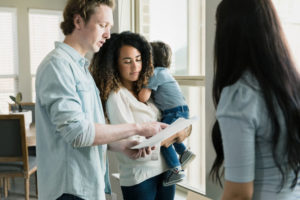 Parents review papers with a lawyer at a birth injury law firm