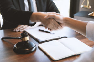 An attorney shakes hands with a client