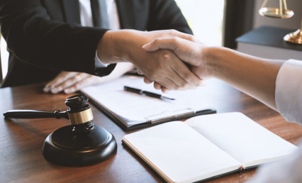 A lawyer shakes hands with a client