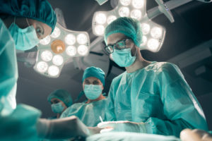 Doctors performing surgery on cancer patient