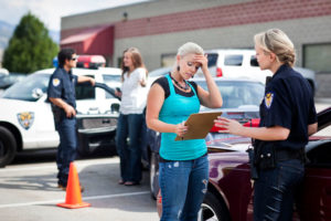 Car accident victim gives information to a police officer 