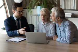 An older couple discuss a slip and fall lawsuit with their attorney