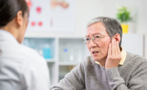 A man sees a doctor about hearing loss
