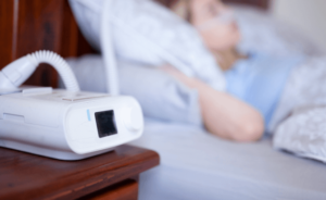 A person uses a CPAP machine while they sleep