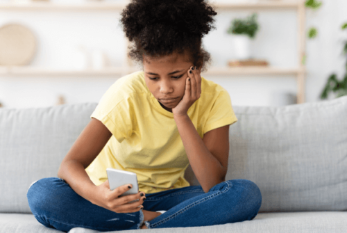 A child stares at a cell phone
