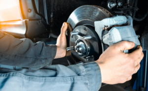 A mechanic works with asbestos-laden brake parts