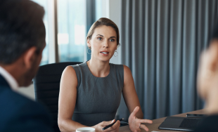 An attorney talks with a client
