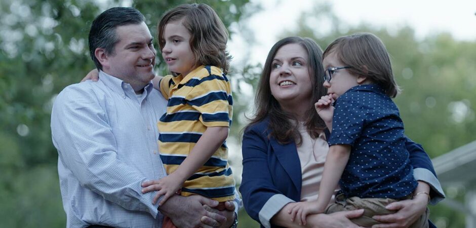 Jessica Blackford Cleeton and her husband and two sons pose for an outdoor photo.