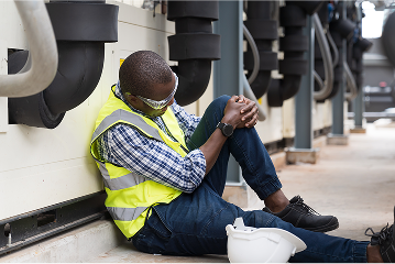A worker clutches his knee
