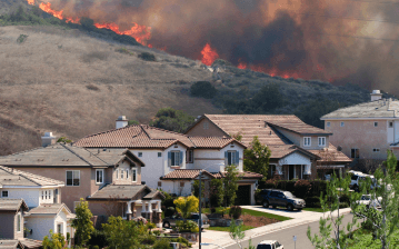 A wildfire breaks out in a residential neighborhood